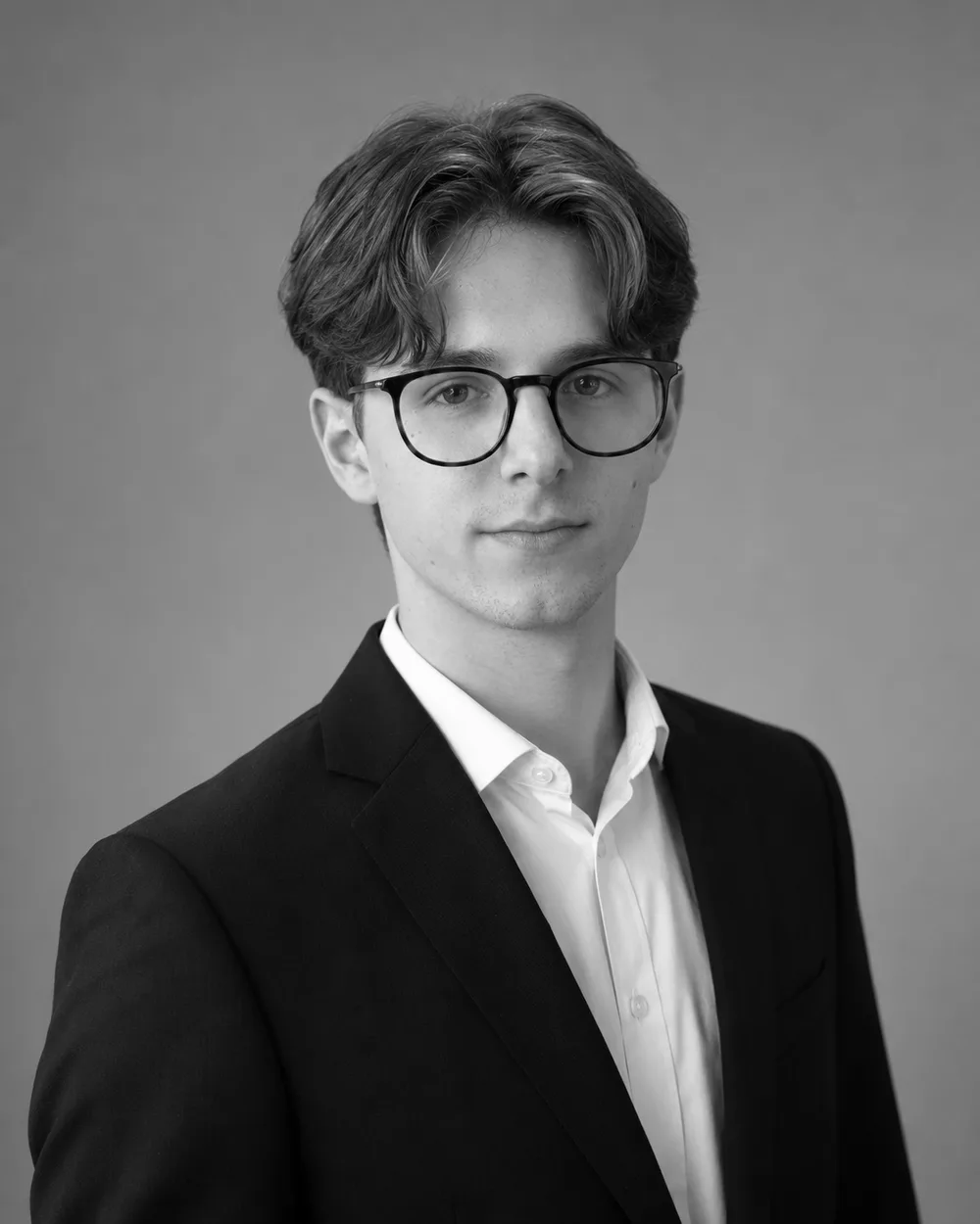 Tom Stieh, founder of Volantic, in a dark suit — black-and-white portrait